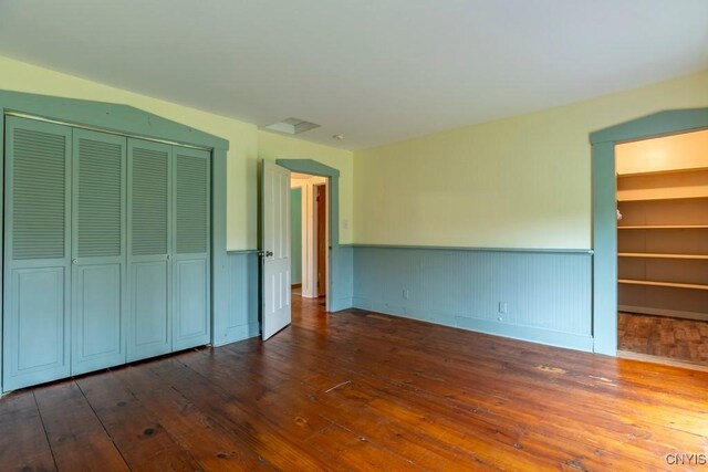 1957 Torpy Pond Rd, Georgetown, NY 13061 - unfurnished bedroom with a closet and dark wood-style flooring