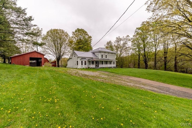 1957 Torpy Pond Rd, Georgetown, NY 13061 - view of front of home with a garage, a front yard, an outbuilding, and driveway