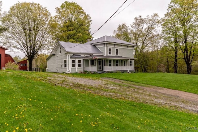 1957 Torpy Pond Rd, Georgetown, NY 13061 - view of front facade with a front lawn, metal roof, and covered porch