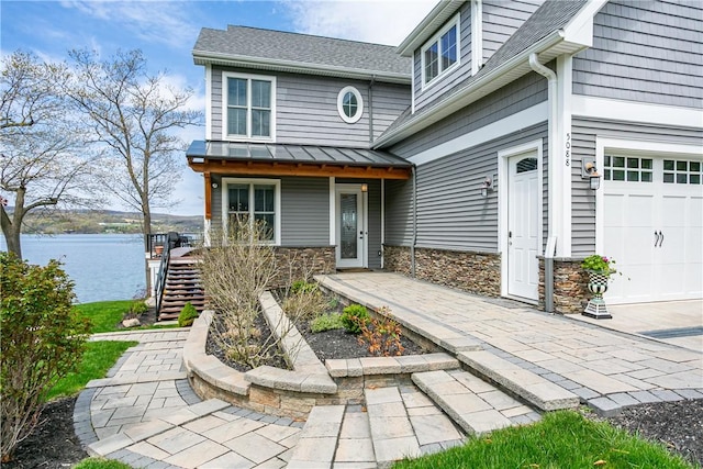 5088 E Lake Rd, Gorham, NY 14544 - property entrance with a standing seam roof, a water view, roof with shingles, stone siding, and a porch