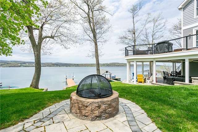 5088 E Lake Rd, Gorham, NY 14544 - view of grassy yard with a balcony, an outdoor fire pit, a patio area, and a water view