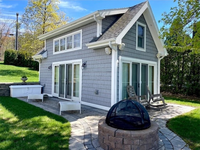 5088 E Lake Rd, Gorham, NY 14544 - rear view of house with a fire pit, a patio, a lawn, and roof with shingles