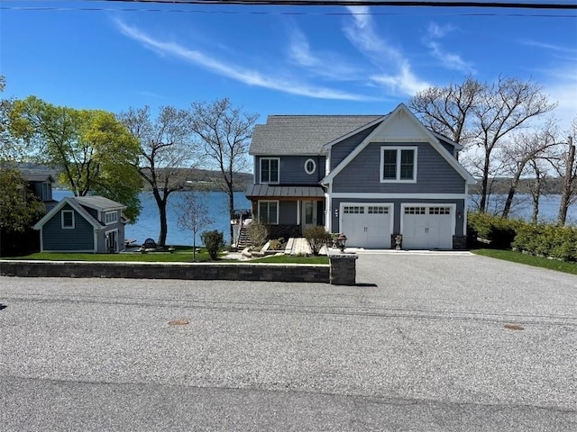 5088 E Lake Rd, Gorham, NY 14544 - view of front of house featuring a standing seam roof, a water view, an attached garage, and driveway