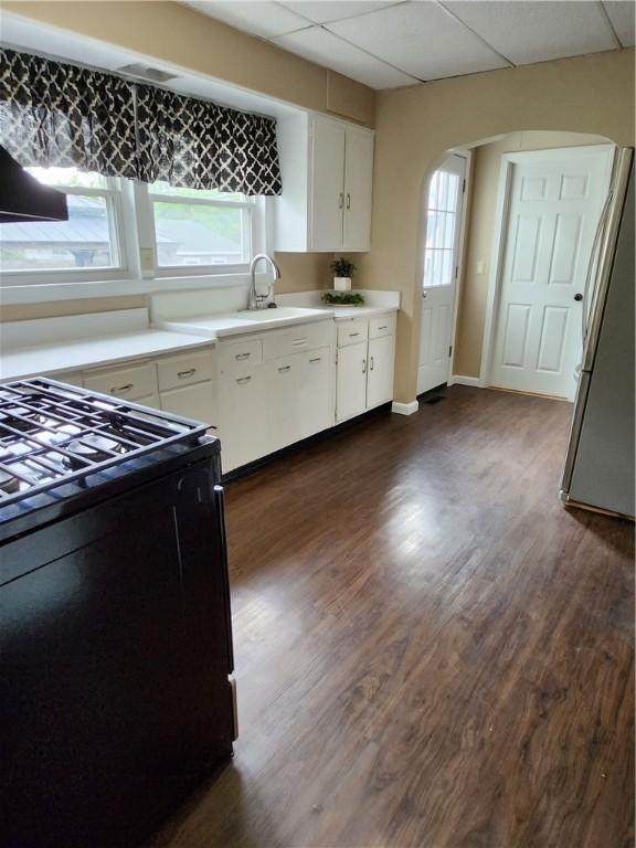 515 Park Pl, Erwin, NY 14870 - kitchen with black gas stove, a sink, arched walkways, healthy amount of natural light, and a paneled ceiling