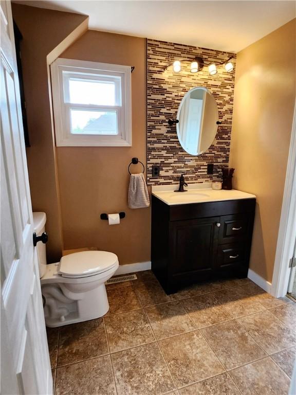 515 Park Pl, Erwin, NY 14870 - bathroom with toilet, baseboards, vanity, tasteful backsplash, and tile patterned flooring