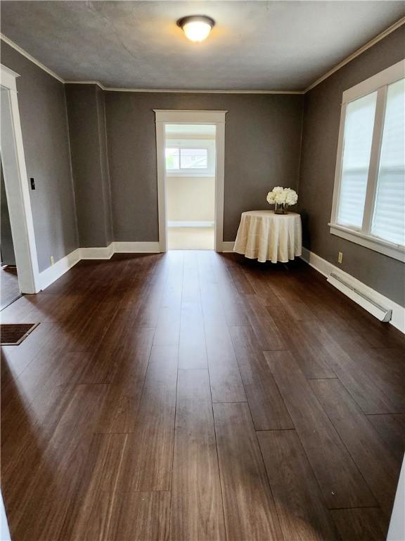 515 Park Pl, Erwin, NY 14870 - empty room featuring a baseboard heating unit, crown molding, dark wood finished floors, and baseboards