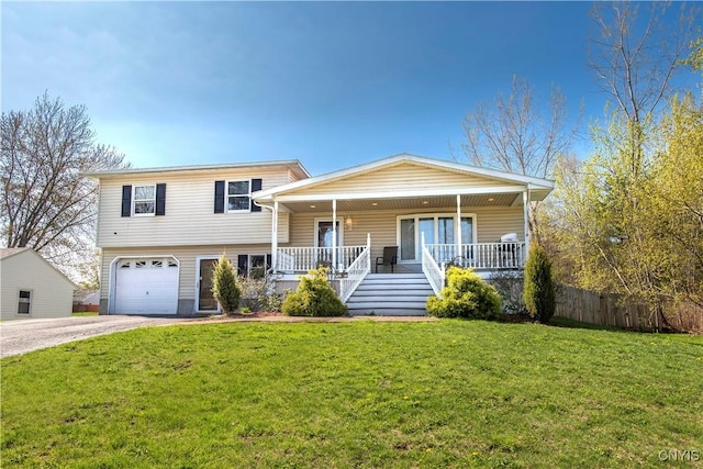 tri-level home with covered porch, driveway, an attached garage, and stairs