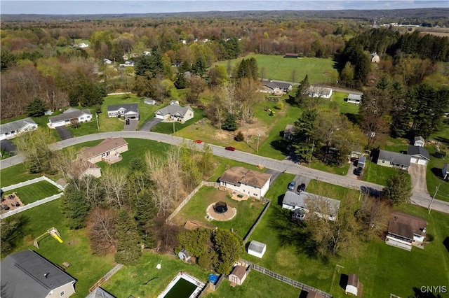 aerial view of property's location with a forest and nearby suburban area