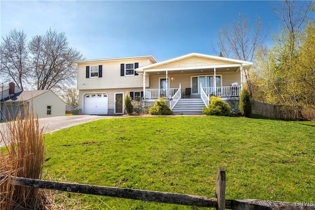 split level home with a porch, driveway, and an attached garage