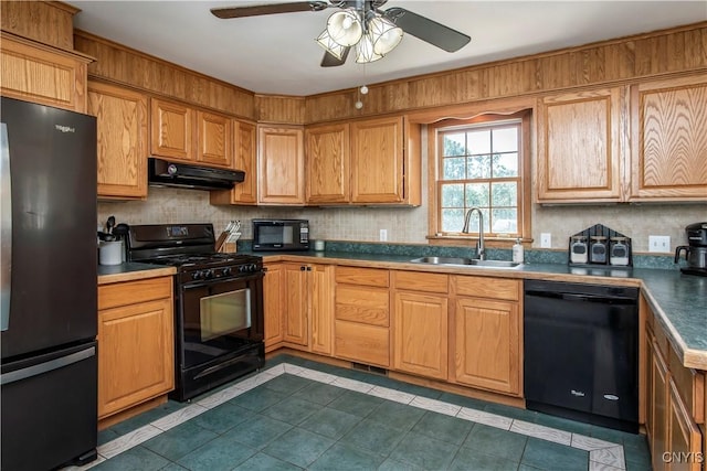kitchen featuring black appliances, a sink, under cabinet range hood, tile patterned floors, and a ceiling fan