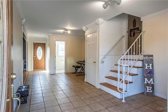foyer with crown molding, stairs, light tile patterned flooring, and baseboards