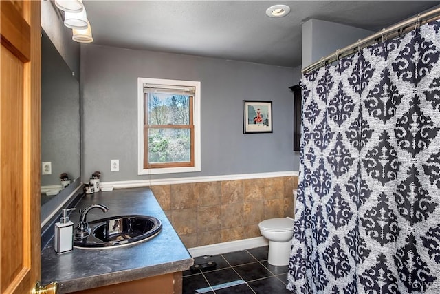 full bath with toilet, vanity, wainscoting, tile patterned flooring, and a shower with shower curtain