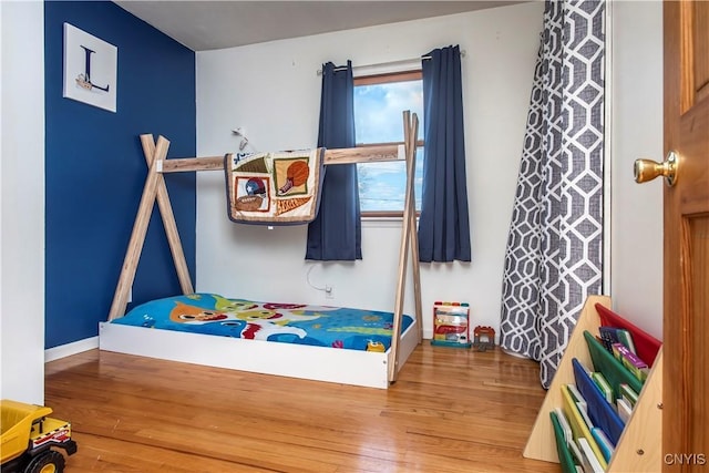 bedroom with wood finished floors