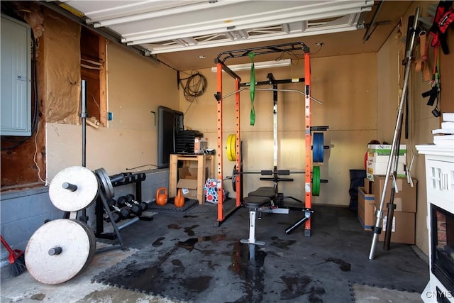 exercise area with electric panel and a garage