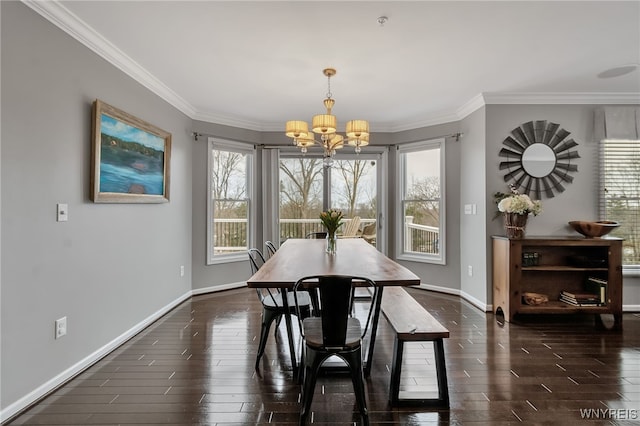 dining room with a chandelier, baseboards, healthy amount of natural light, and ornamental molding