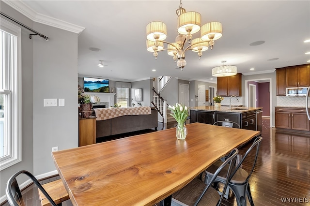 dining area featuring stairway, crown molding, dark wood-style floors, recessed lighting, and a fireplace
