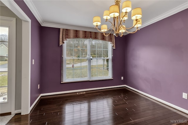 unfurnished dining area with a chandelier, plenty of natural light, wood finished floors, ornamental molding, and baseboards