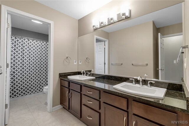 905 Sullivan Ct, Lewiston, NY 14092 - full bathroom with double vanity, toilet, baseboards, and a shower with curtain