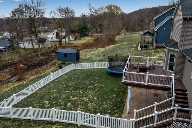 905 Sullivan Ct, Lewiston, NY 14092 - view of yard featuring a trampoline, a wooden deck, stairs, and a storage unit