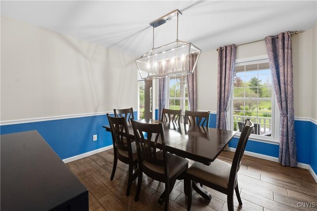 dining room featuring baseboards and wood finished floors