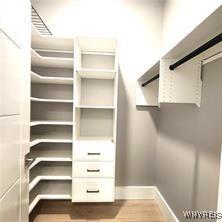 spacious closet featuring wood finished floors