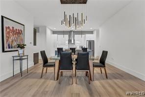 dining room with light wood-style floors and baseboards
