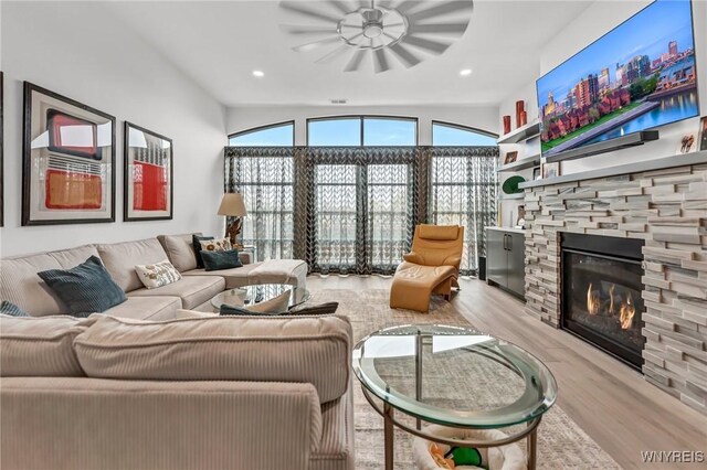living area featuring wood finished floors, a fireplace, and recessed lighting