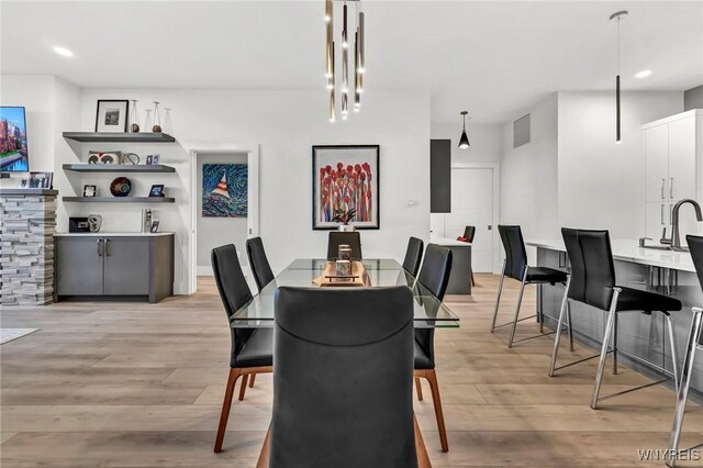 dining area featuring light wood-style flooring and recessed lighting