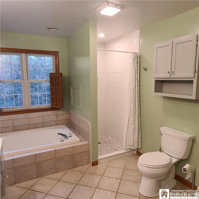 384 Flickerwood Rd, Kane-Borough, PA 16735 - bathroom with tile patterned floors, a stall shower, toilet, a garden tub, and baseboards