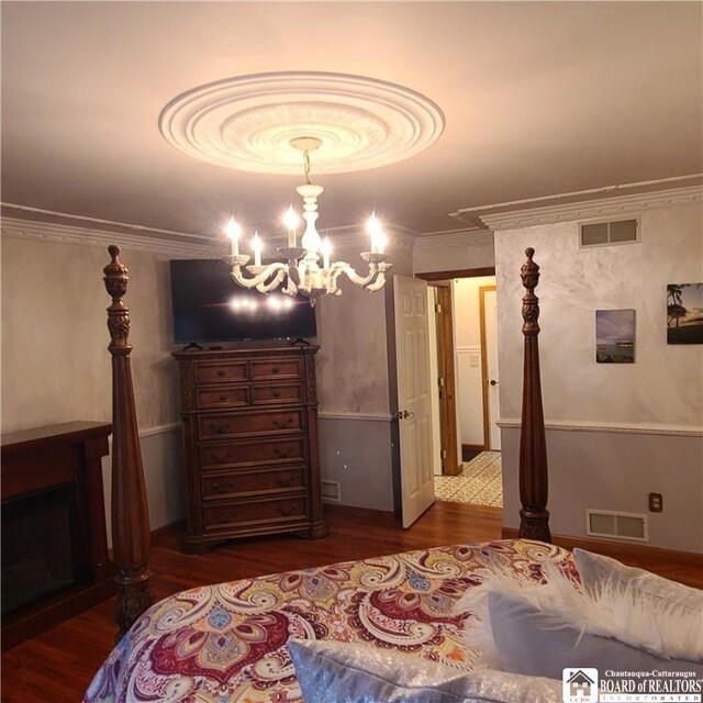 384 Flickerwood Rd, Kane-Borough, PA 16735 - bedroom with wood finished floors, a chandelier, and crown molding