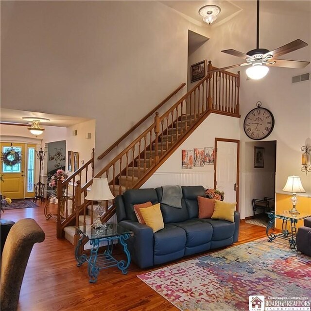384 Flickerwood Rd, Kane-Borough, PA 16735 - living area featuring stairs, wood finished floors, a towering ceiling, and ceiling fan