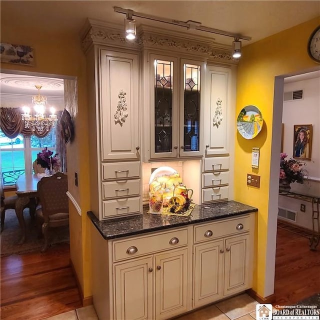 384 Flickerwood Rd, Kane-Borough, PA 16735 - bar area with a chandelier, light wood finished floors, baseboards, and rail lighting