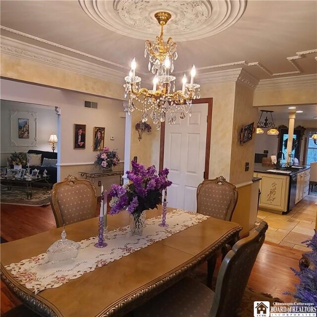 384 Flickerwood Rd, Kane-Borough, PA 16735 - dining space featuring ornamental molding, light wood-style flooring, a chandelier, and a raised ceiling