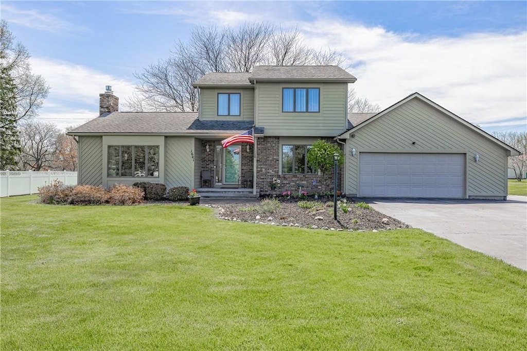 1641 Woodard Rd, Webster, NY 14580 - view of front facade featuring a chimney, concrete driveway, a garage, and a shingled roof