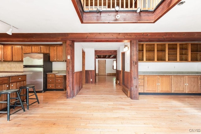 1826 Cardner Rd, Fabius, NY 13122 - kitchen featuring freestanding refrigerator, brown cabinetry, light wood-type flooring, light countertops, and track lighting