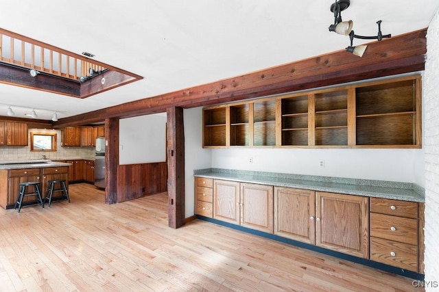 1826 Cardner Rd, Fabius, NY 13122 - kitchen with freestanding refrigerator, light wood-style flooring, brown cabinetry, and light countertops