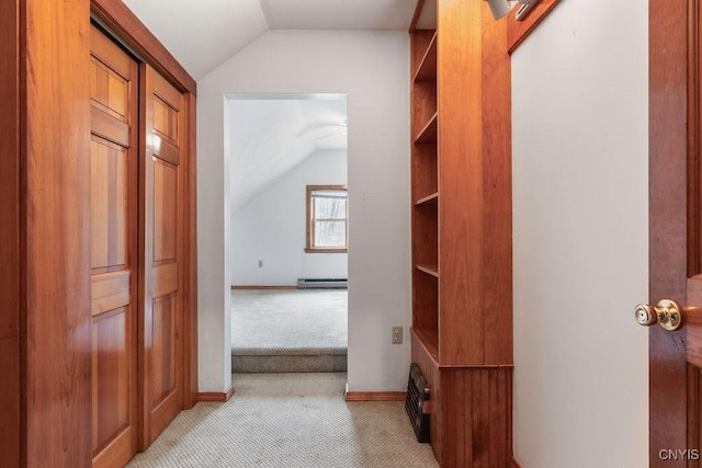 1826 Cardner Rd, Fabius, NY 13122 - hallway with vaulted ceiling, light carpet, a baseboard radiator, and baseboards