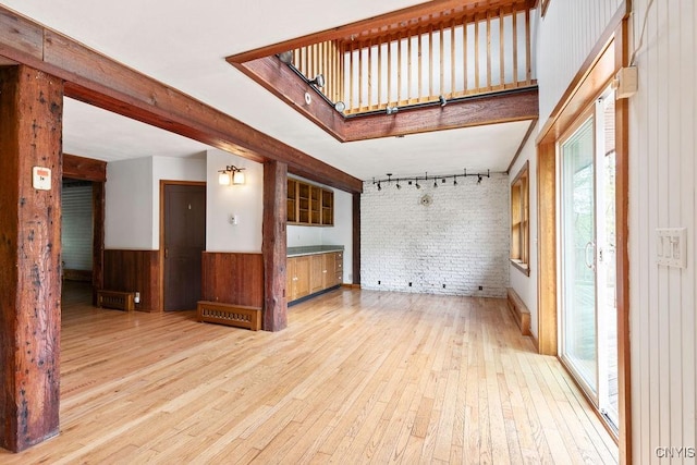1826 Cardner Rd, Fabius, NY 13122 - unfurnished room with hardwood / wood-style floors, healthy amount of natural light, brick wall, wood walls, and a wainscoted wall