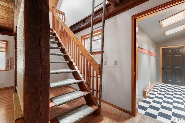 1826 Cardner Rd, Fabius, NY 13122 - stairs with plenty of natural light, lofted ceiling, baseboards, and wood finished floors