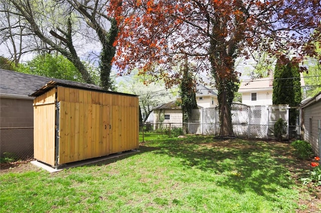 view of yard featuring a storage unit and an outbuilding