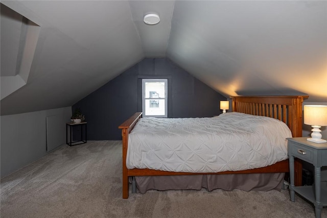 carpeted bedroom featuring lofted ceiling