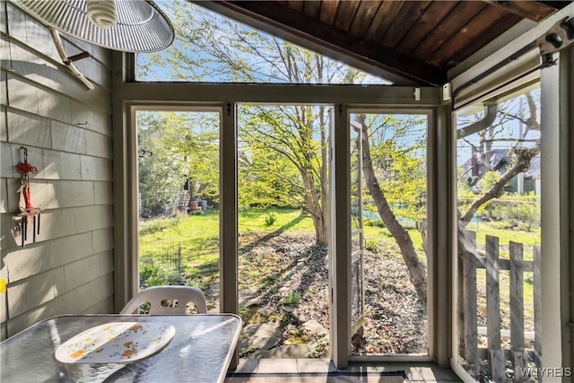 sunroom with lofted ceiling and plenty of natural light