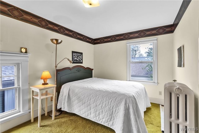 carpeted bedroom featuring baseboards