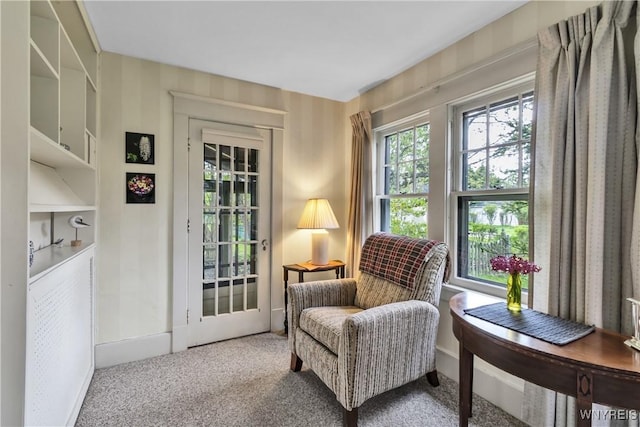 living area with carpet flooring and baseboards