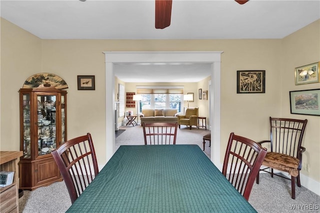 dining room featuring carpet floors and a ceiling fan