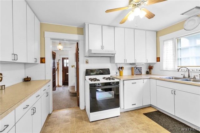 kitchen with gas stove, dishwasher, under cabinet range hood, a sink, and light countertops