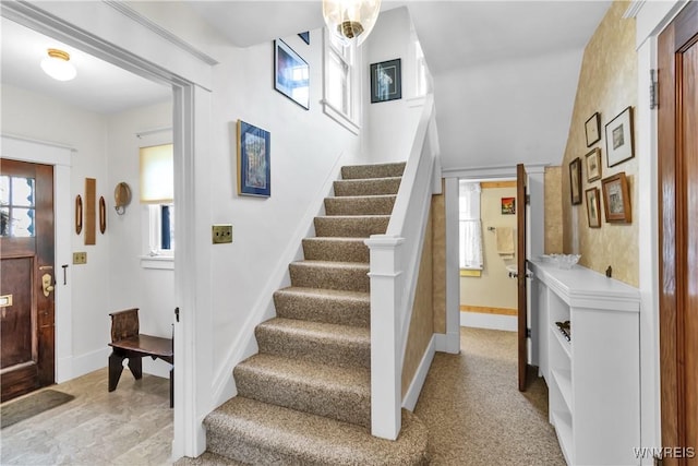 entryway with stairway and baseboards
