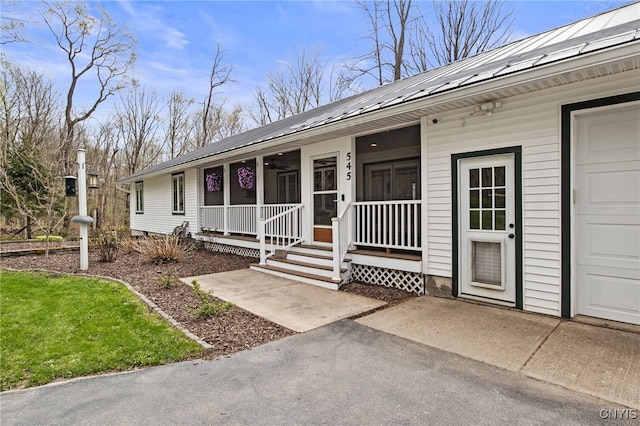 545 County Route 54, Schroeppel, NY 13132 - doorway to property featuring a porch and metal roof