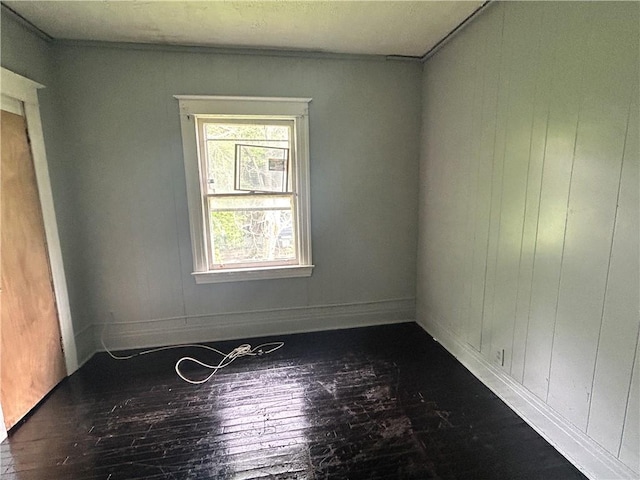 unfurnished room with hardwood / wood-style flooring