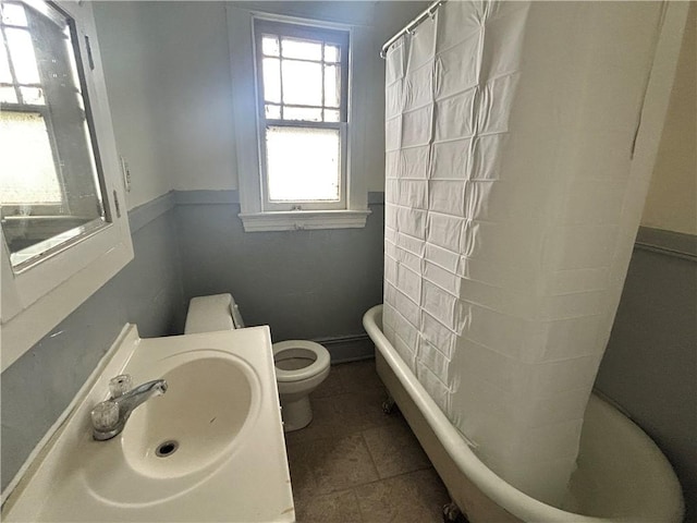 full bathroom featuring a sink, toilet, a bathtub, curtained shower, and tile patterned floors